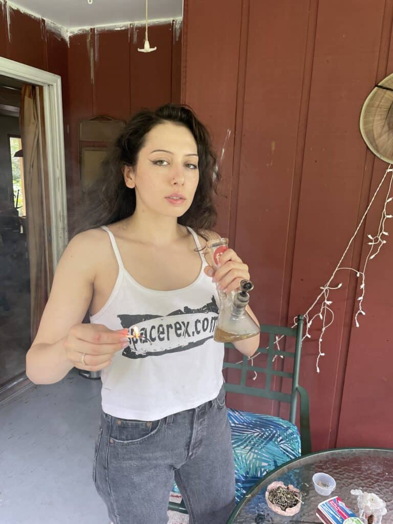Pretty girl in spacerex spaghetti strap shirt ripping a bong