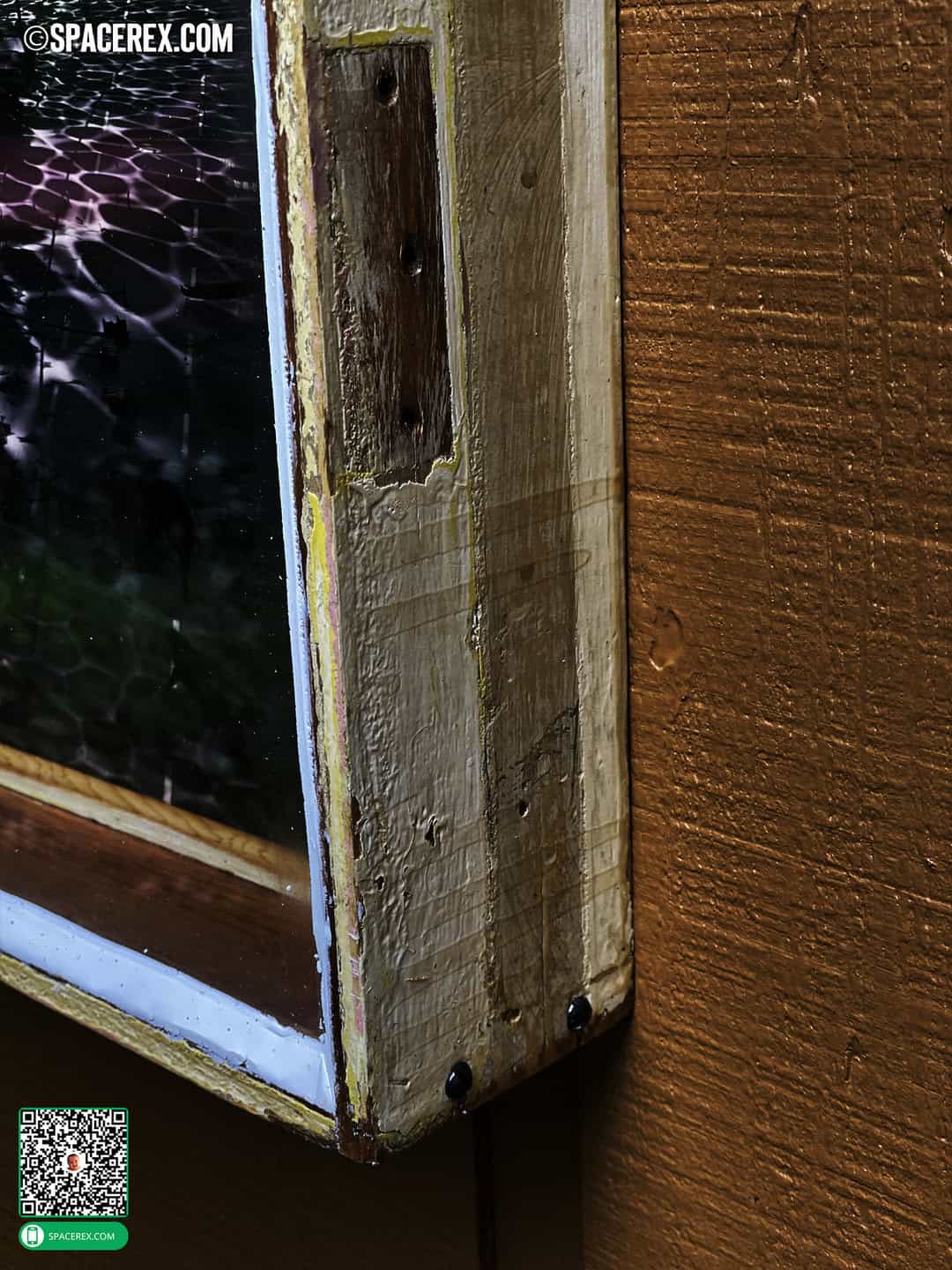 Wider detail of reclaimed wooden art frame featuring antique slotted screws and flaking paint, shellacked to a shiny goodness, and showing the bare patch where a hinge used to be mounted.